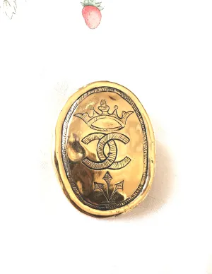 Vintage CHANEL gold tone large brooch in oval coin shape with CC logo and crown embossed motif. Rare masterpiece jewelry. 060620re3