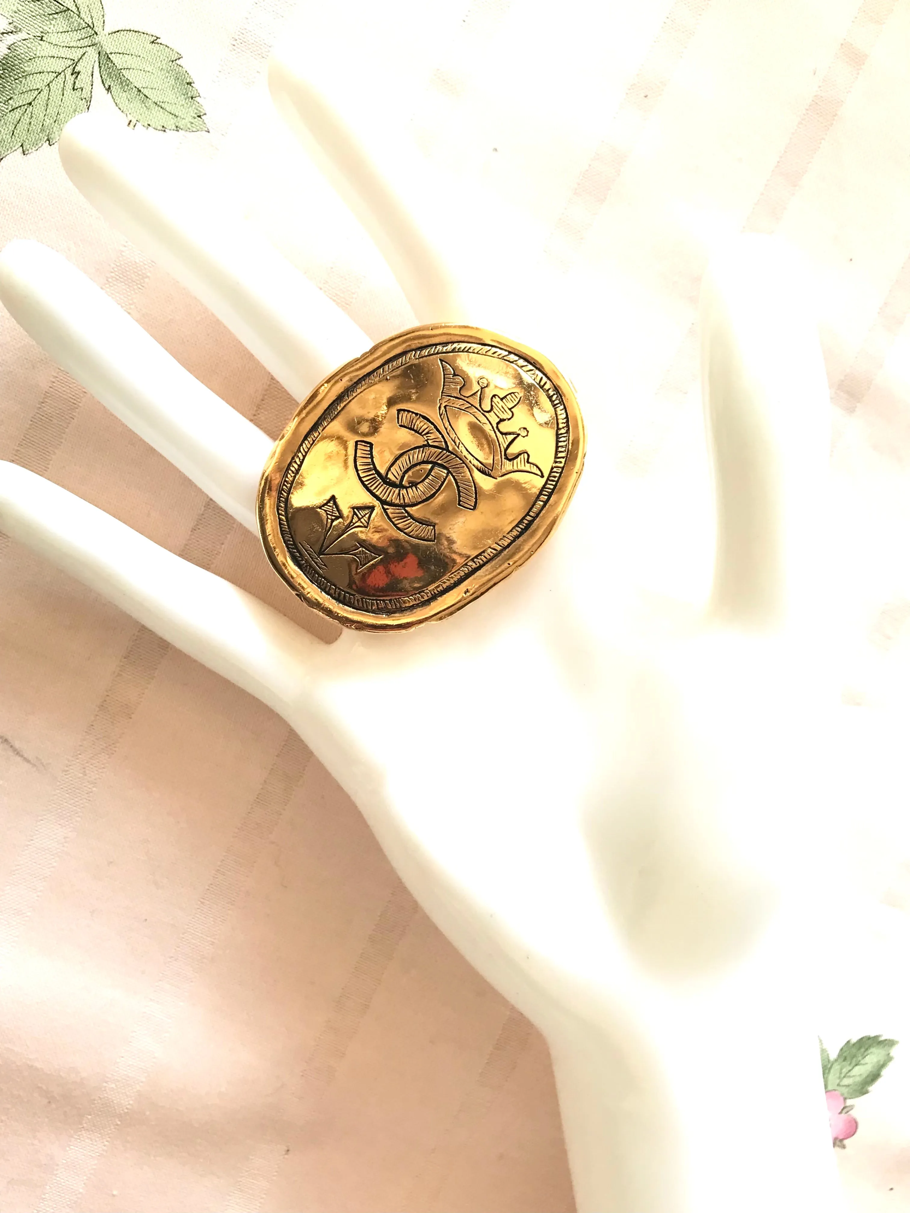 Vintage CHANEL gold tone large brooch in oval coin shape with CC logo and crown embossed motif. Rare masterpiece jewelry. 060620re3